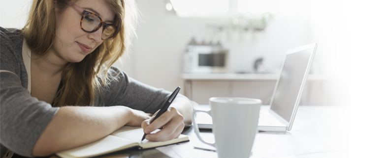 Woman writing in a journal