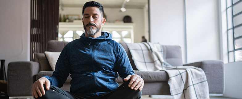 Person meditating to reduce stress.