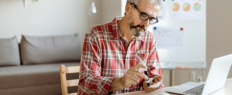 Person testing blood sugar at home.