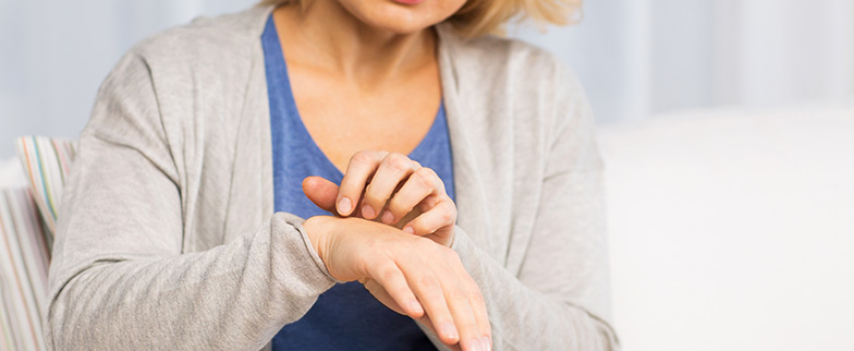 Scratching hand with dry skin.