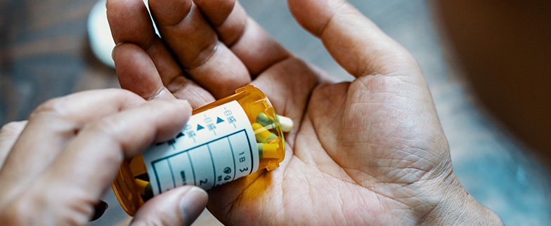 Prescription drugs in persons hands.