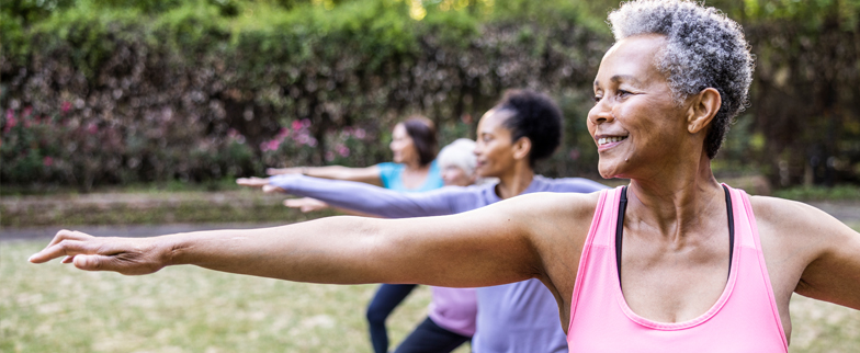 A group of adults participating in a yoga exercise.  