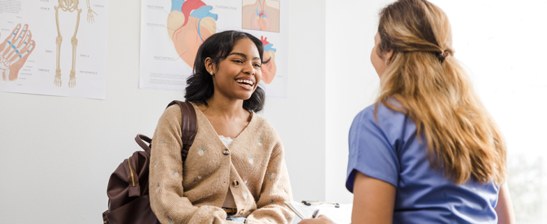 A teen talking with a medical professional about the Meningococcal vaccine.