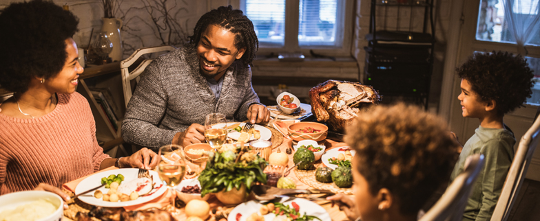 A family enjoying their thanksgiving dinner together. 