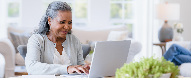 Adult learning about health insurance on their computer in their home